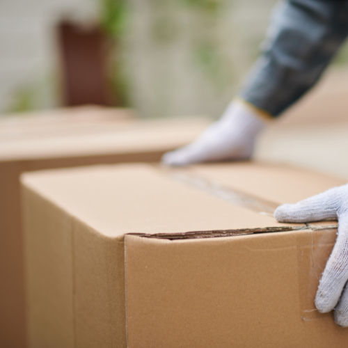 A cardboard box being grabbed