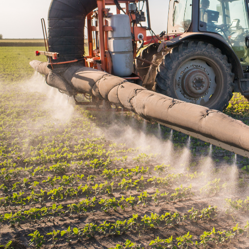 Tractor spraying a crop field